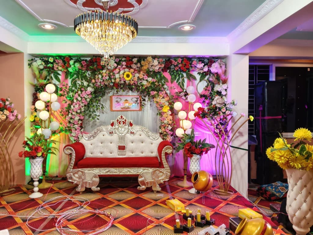 Milan Palace decorated stage with floral backdrop and chandelier